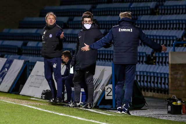 Posh assistant manager Mark Robson (left) and Gillingham assistant manager Paul Raynor on the touchline as tempers flare. Photo: Joe Dent/theposh.com.