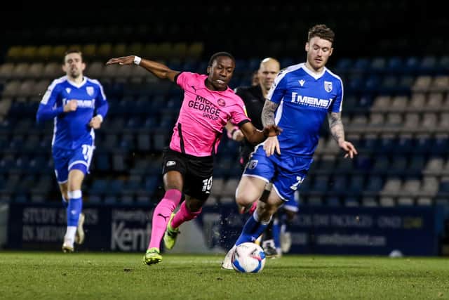 Posh star Siriki Dembele in action with Callum Slattery of Gillingham last night. Photo: Joe Dent/theposh.com.