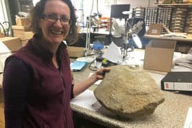Dr Ruth Shaffrey with the millstone, only one of four such carvings ever found on these millstones