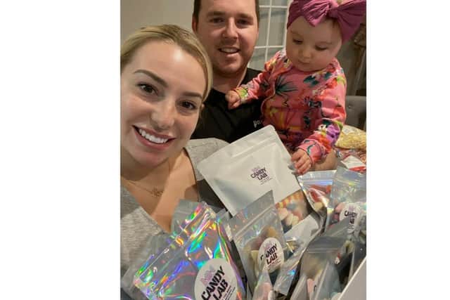 Laura, Frazer and their daughter Piper with a hamper of goody bags.