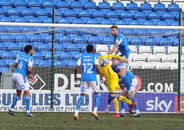 Posh skipper Mark Beevers rose highest to clear this AFC Wimbledon attack. Photo: David Lowndes.
