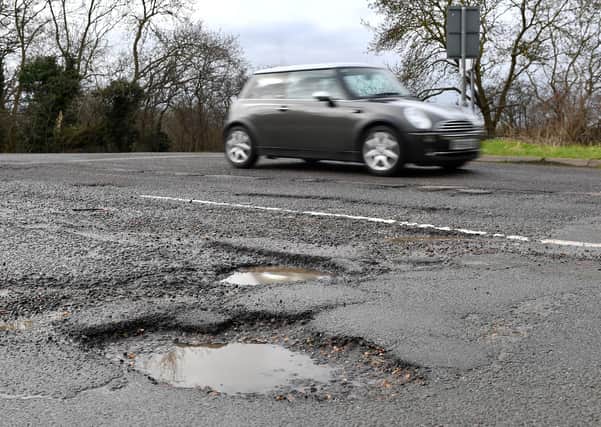 Government funding to repair damaged roads in Cambridgeshire and Peterborough has been slashed by a quarter for the coming year. Photo: PA EMN-210224-172901001