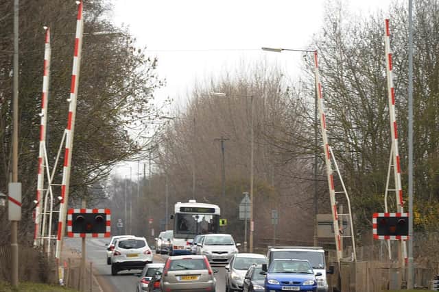 The A605 Kings Dyke railway crossing.