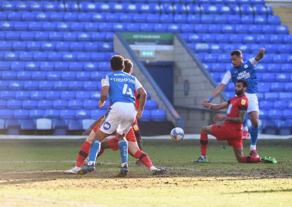 Posh striker Jonson Clarke-Harris shoots at the Wigan goal. Photo: David Lowndes.