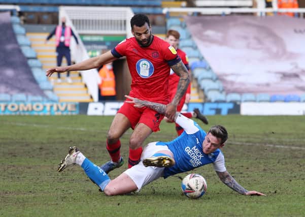 Sammie Szmodics of Peterborough United battles for the ball with Curtis Tilt of Wigan Athletic. Photo: Joe Dent/theposh.com.