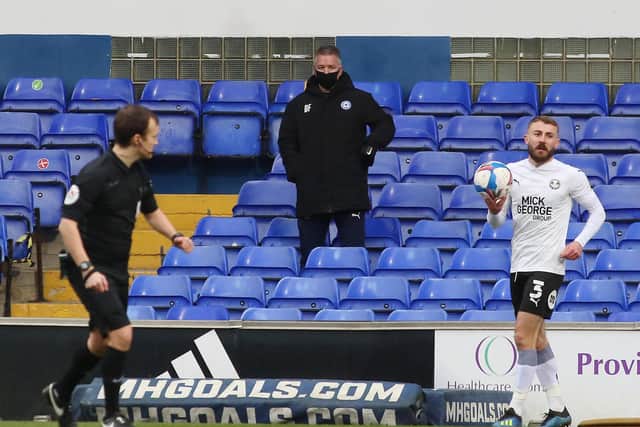 Posh boss Darren Ferguson watches on from the stand as Dan Butler prepares to take a throw-in.