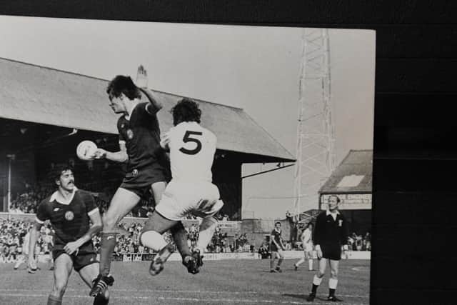 Bobby Doyle (aerial, left) in action for Posh.