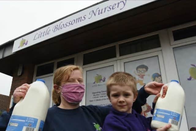 Charlotte Tuffs, deputy manager of Little Blossoms Nursery at Werrington with four-year-old Alfie and some of the milk donated by Tesco following a milk theft at the nursery
