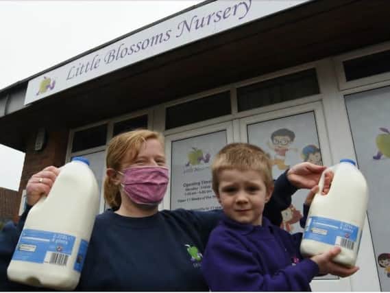 Charlotte Tuffs, deputy manager of Little Blossoms Nursery at Werrington with four-year-old Alfie and some of the milk donated by Tesco following a milk theft at the nursery