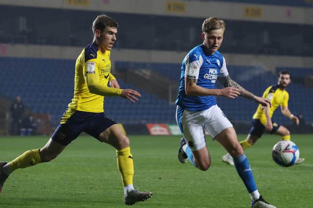 Frankie Kent of Peterborough United in action with Josh Ruffels of Oxford United. Photo: Joe Dent/theposh.com.