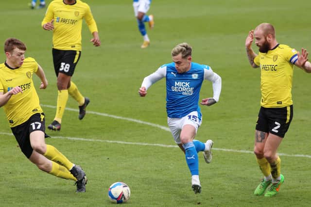 Sammie Szmodics of Peterborough United takes on John Brayford and Hayden Carter of Burton Albion. Photo: Joe Dent/theposh.com.