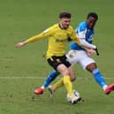 Siriki Dembele of Peterborough United puts pressure on Jonny Smith of Burton Albion. Photo: Joe Dent/theposh.com.