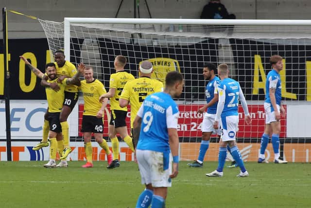 Kane Hemmings and his Burton teammates celebrate the opening goal of the game against Posh. Photo: Joe Dent/theposh.com.