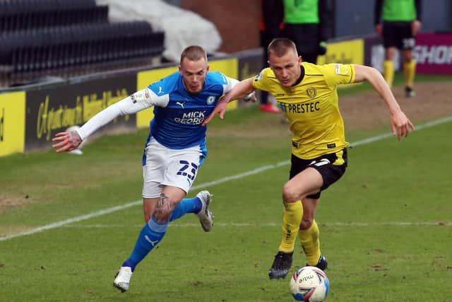 Joe Ward of Peterborough United battles with Hayden Carter of Burton Albion. Photo: Joe Dent/theposh.com.