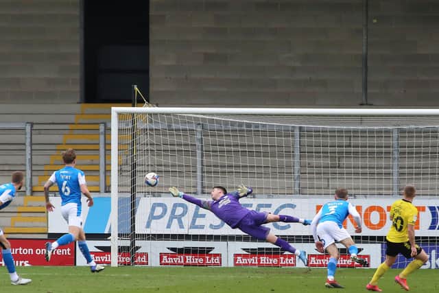 Christy Pym of Peterborough United makes a diving save against Burton Albion. Photo: Joe Dent/theposh.com.