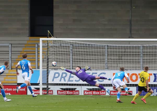 Christy Pym of Peterborough United makes a diving save against Burton Albion. Photo: Joe Dent/theposh.com.