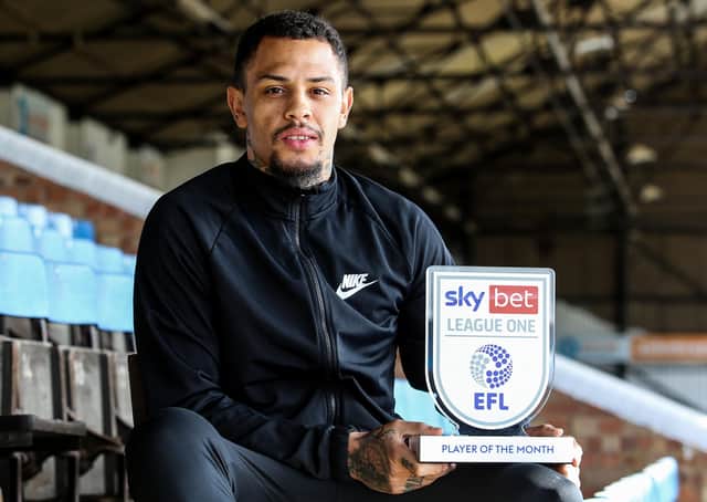 Jonson Clarke-Harris with his Player of the Month trophy.