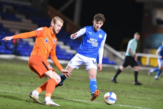 Harrison Burrows battles for the ball with Ronan Curtis.