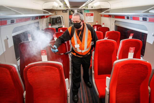 A cleaner uses a fogging machine to clean a train carriage during the night, as a team of 360 specialists work around-the-clock to deliver London North Eastern Railway's 'Covid Secure' enhanced cleaning pledge to keep customers who need to make necessary journeys safe during the pandemic. PA Photo. EMN-210317-123957001