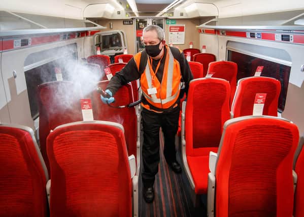 A cleaner uses a fogging machine to clean a train carriage during the night, as a team of 360 specialists work around-the-clock to deliver London North Eastern Railway's 'Covid Secure' enhanced cleaning pledge to keep customers who need to make necessary journeys safe during the pandemic. PA Photo. EMN-210317-123957001
