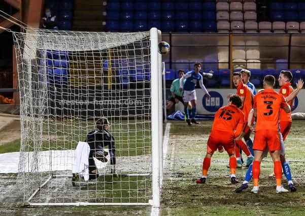 Posh teenager Harrison Burrows watches on as his corner hits the back of the Pompey net. Photo: David Lowndes.