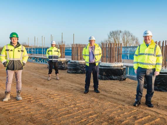 Rhydian Hafal, construction manager, Jones Bros; Lee Baldry, team leader - major projects, Cambridgeshire County Council; Cllr David Connor; and Cllr Steve Count standing on the first earth reinforced abutment.