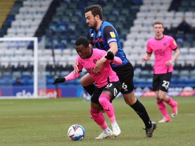 Siriki Dembele of Peterborough United is held back by Eoghan O'Connell of Rochdale. Photo: Joe Dent/theposh.com.