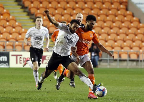 Nathan Thompson of Peterborough United battles with Grant Ward of Blackpool. Photo: Joe Dent/theposh.com.