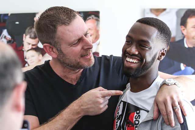 Posh co-owner Darragh MacAnthony with club record signing Mo Eisa.