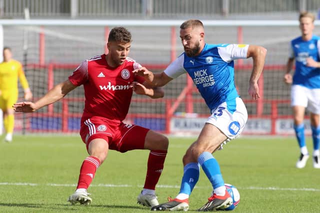 Accrington Stanley top scorer Dion Charles (left) misses the game at Posh.