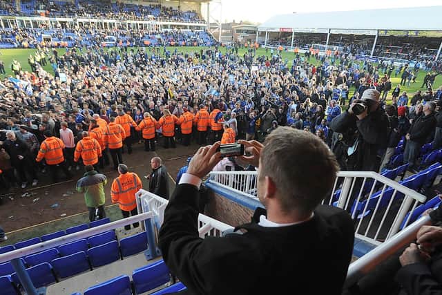 Posh chief Darragh MacAnthony in front of the club's fans.