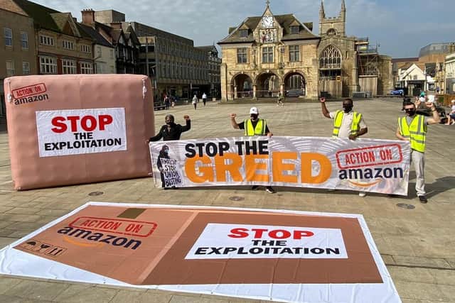 Representatives of Unite protest in Cathedral Square, in Peterborough.