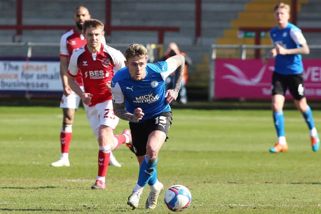 Sammie Szmodics of Peterborough United gets away from Sam Finley of Fleetwood Town. Photo Joe Dent/theposh.com