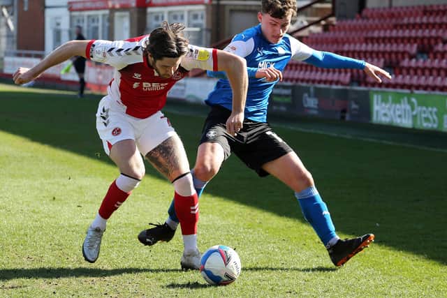 Harrison Burrows of Peterborough United battles with Wes Burns of Fleetwood Town. Photo: Joe Dent/theposh.com.