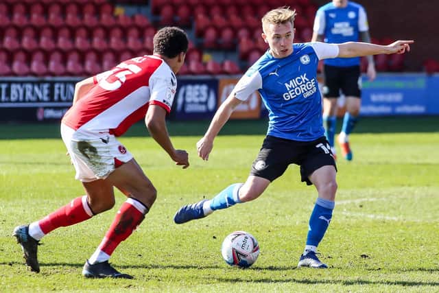 Posh midfielder Louis Reed in action with James Hill of Fleetwood Town. Photo: Joe Dent/theposh.com.