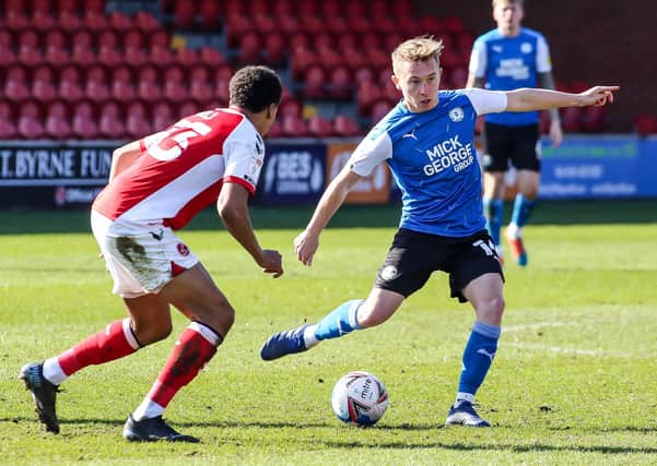Posh midfielder Louis Reed in action with James Hill of Fleetwood Town. Photo: Joe Dent/theposh.com.