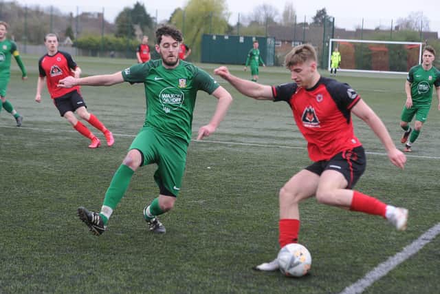 Robbie Ellis (red) in action for Netherton against Cottesmore last weekend.  Photo: David Lowndes.