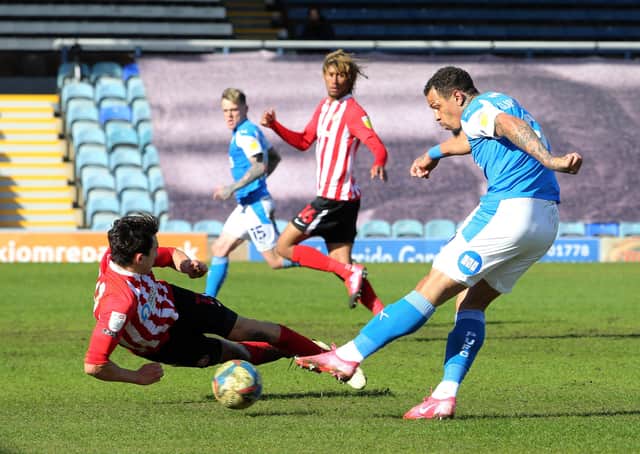 Jonson Clarke-Harris of Peterborough United has a shot blocked by Luke O'Nien of Sunderland. Photo: Joe Dent/theposh.com.