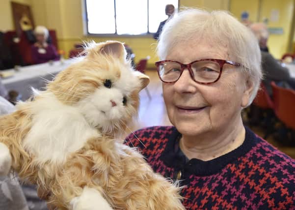 Dementia patient Zofia Kowakzk with one of  the robotic cats