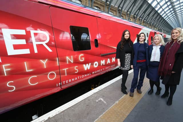 Sisters (left to right) Ellie Tyrrell, Kelly Measures, Toni Measures and Jamie Tyrrell stand beside the Flying Scotswoman to celebrate their arrival at King's Cross station. Photo: Jonathan Brady/PA Wire RAIL_Women_13100310.JPG