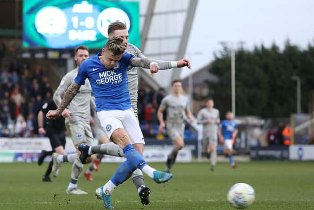 Sammie Szmodics of Peterborough United gets the better of Ronan Curtis of Portsmouth to shoot at goal. Photo: Joe Dent/theposh.com.