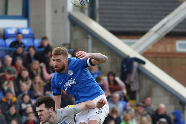 Mark Beevers of Peterborough United in action with John Marquis of Portsmouth. Photo: Joe Dent/theposh.com.