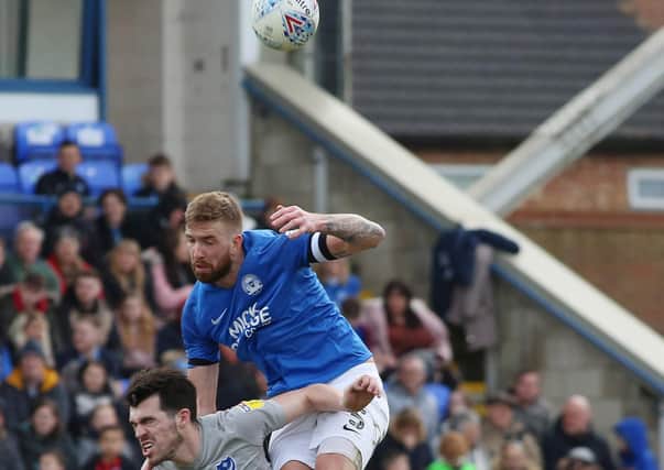 Mark Beevers of Peterborough United in action with John Marquis of Portsmouth. Photo: Joe Dent/theposh.com.