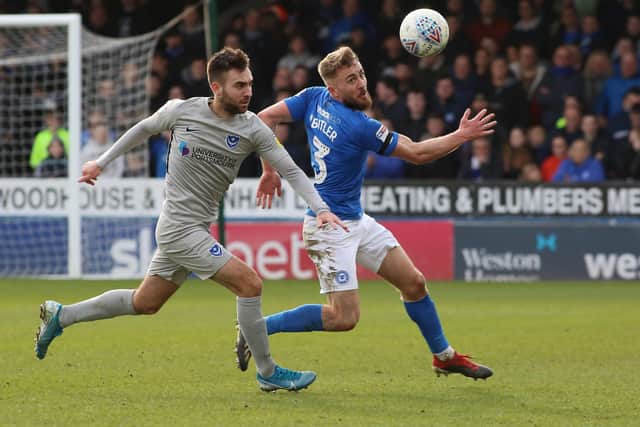 Dan Butler of Peterborough United in action with Ben Close of Portsmouth. Photo: Joe Dent/theposh.com.