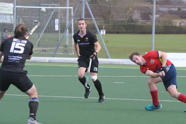 Joe Finding (right) clears the ball for City of Peterborough against Cardiff Met. Photo: David Lowndes.