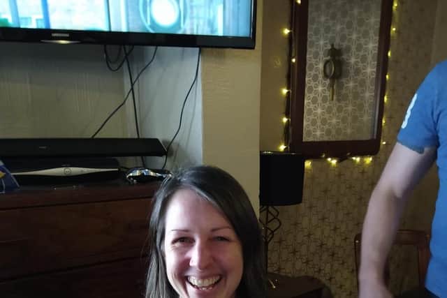 A smiling Vicky before her head shave