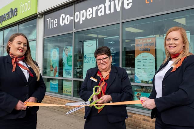Senior Travel Consultant Amy Richardson, Branch Manager Cheryl Cipriano and Travel Consultant Sarah Britton cut the ribbon on their new home.