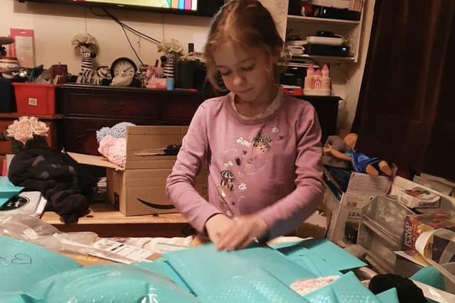 Penny Lanning's daughter Lucy helping to make a memorial pack