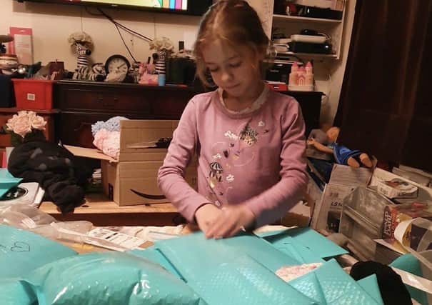 Penny Lanning's daughter Lucy helping to make a memorial pack