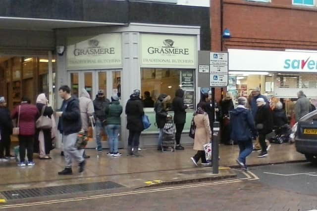 Shoppers queuing outside Savers in Westgate. Photo: Claudia Elliott